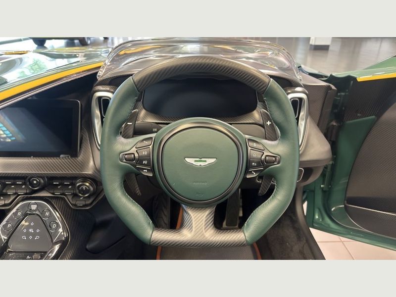 Side profile of a sleek silver Aston Martin V12 Sports Car