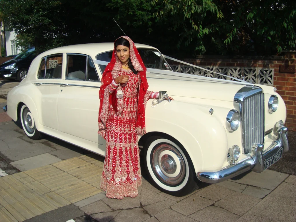 A chauffeur-driven Bentley S1 1956, viewed from the front, ready for hire