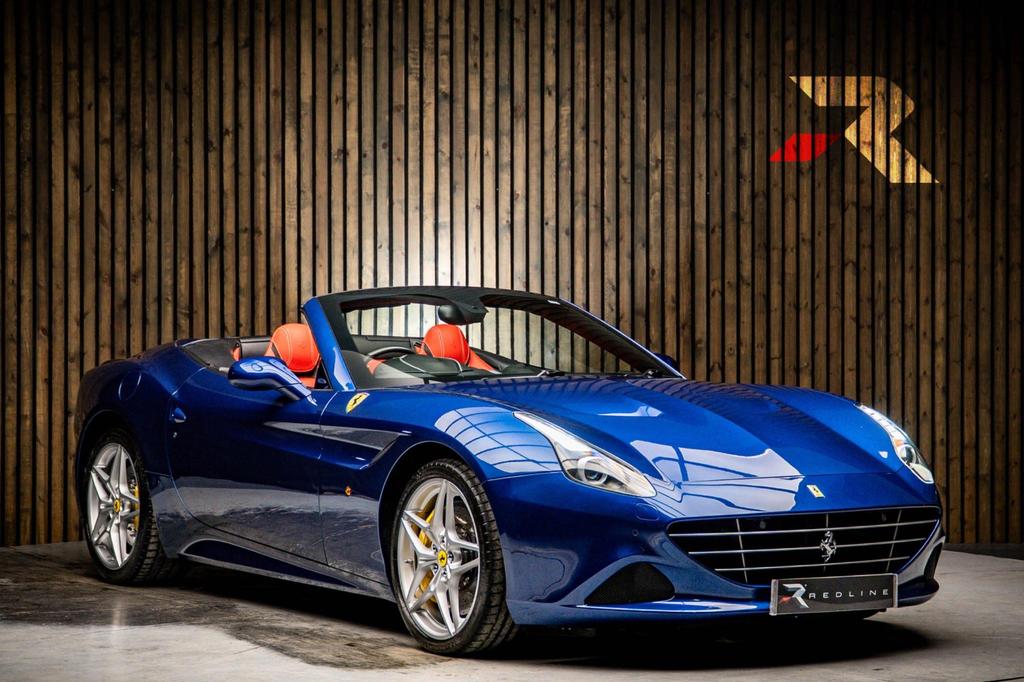 Side profile of a red Ferrari California available for hire