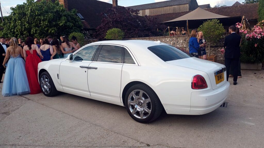 A white Rolls Royce Ghost, perfect for a grand wedding entrance.
