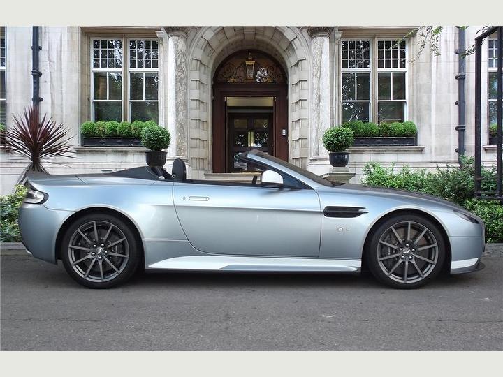 Aston Martin V12 Vantage hiring service image, showing the car in a city setting