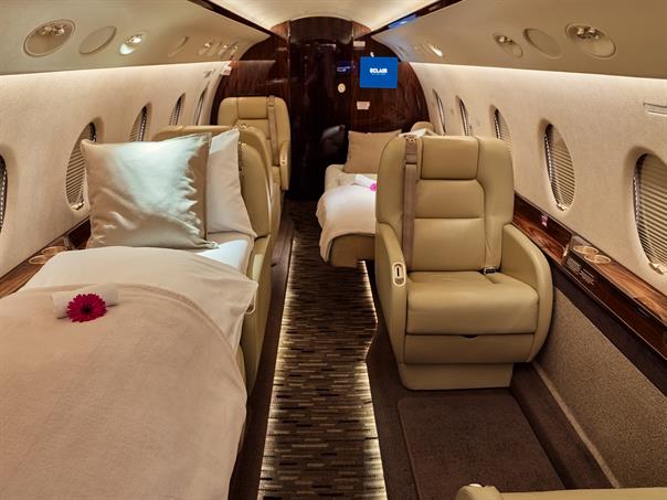 The refined classic interior of a Gulfstream G-200 private jet, featuring plush leather seats and polished wood accents, perfect for luxury travel.